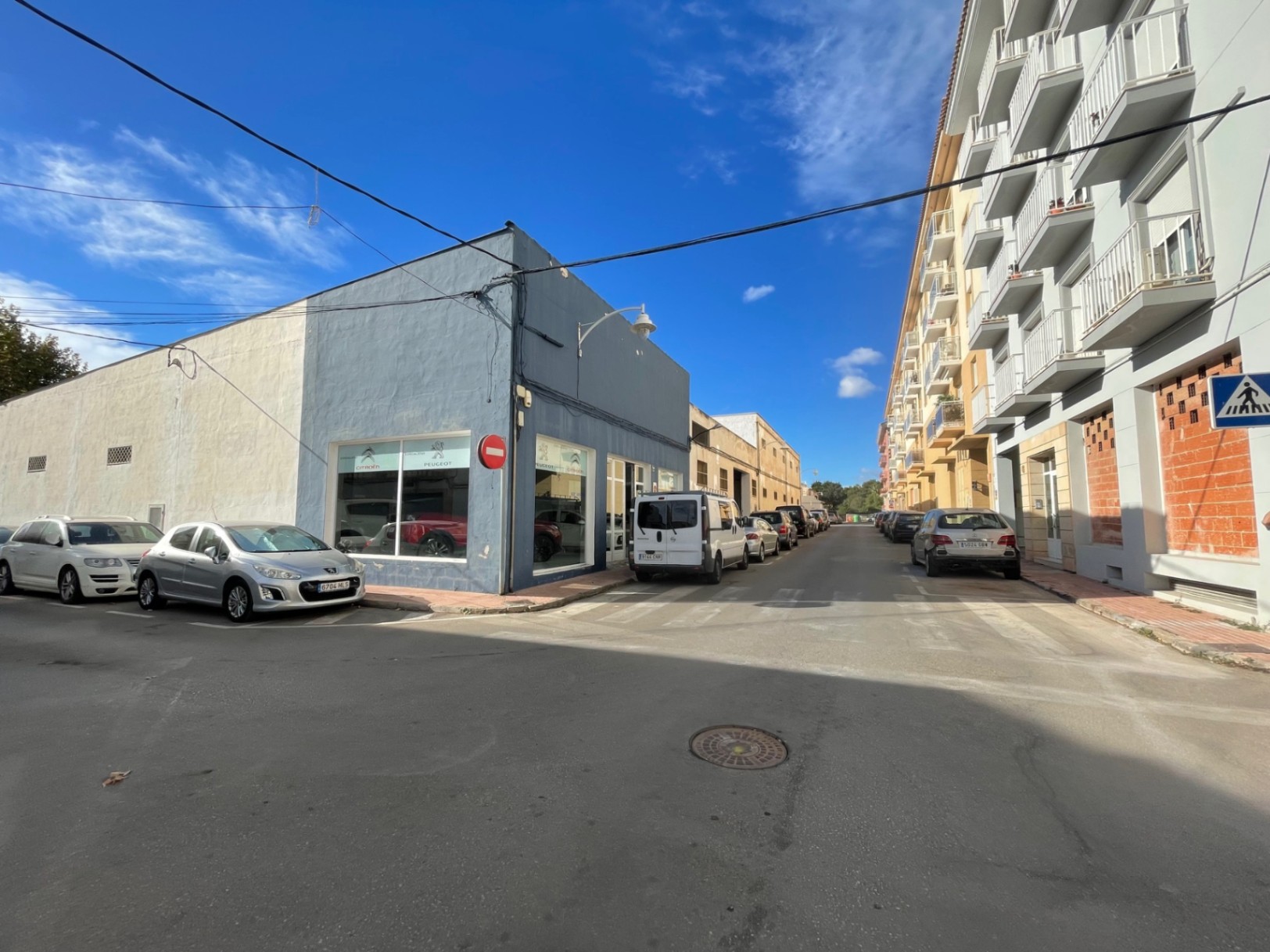 Vista exterior del local comercial en esquina, con amplios escaparates acristalados y acceso directo desde la calle en una zona transitada de Jávea.