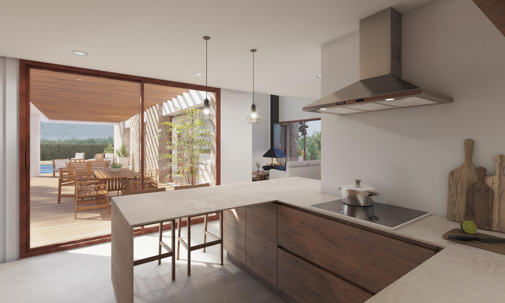 Cocina moderna con isla de madera oscura, encimera de piedra y campana de acero, conectada a una terraza exterior con comedor de madera y vistas al salón con chimenea.