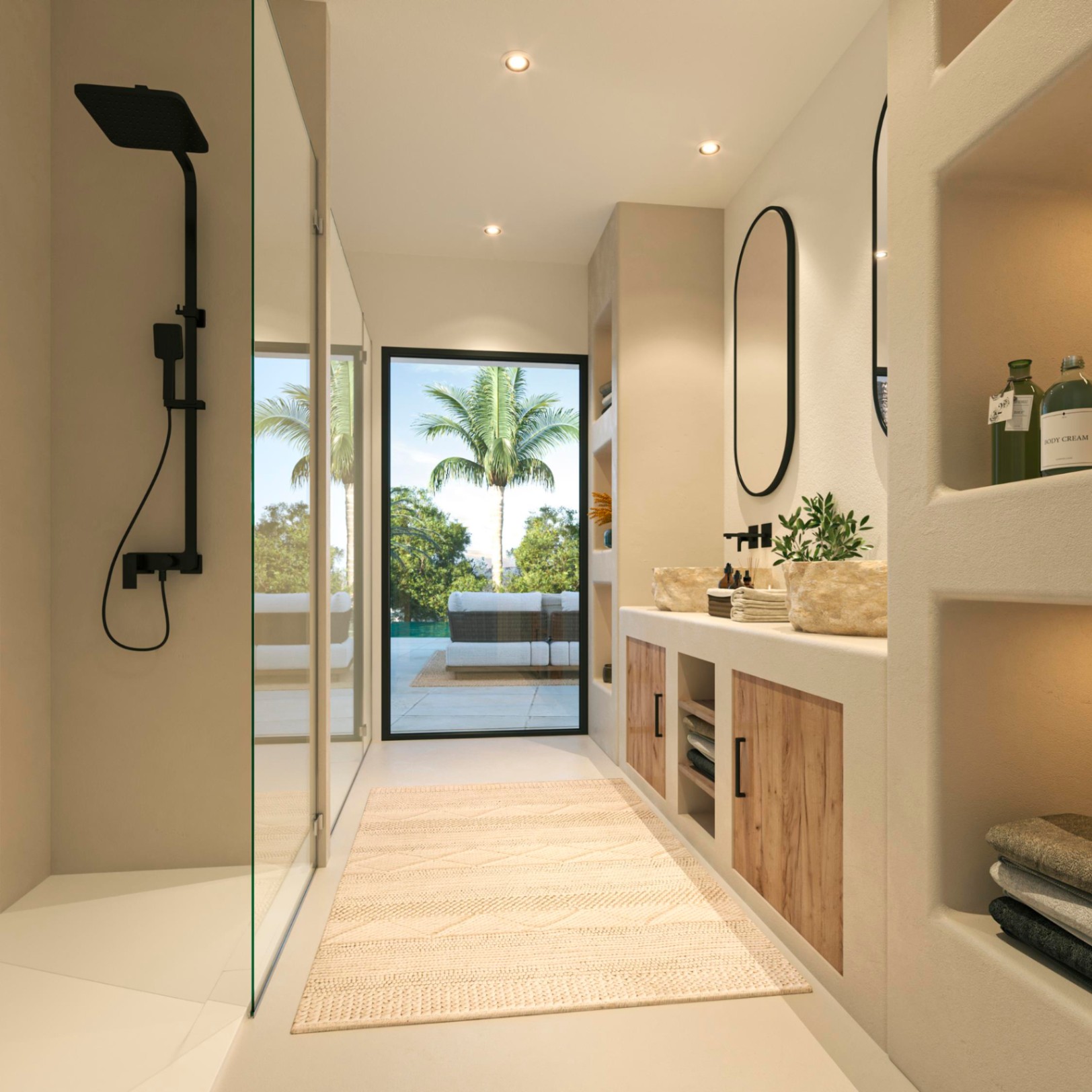 Baño principal con ducha de obra, grifería negra y lavabo doble de piedra sobre mueble de madera. Incluye hornacinas integradas y vistas directas a la terraza con palmeras.